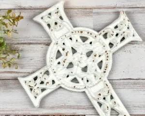 Ornate worn white iron wall hanging cross