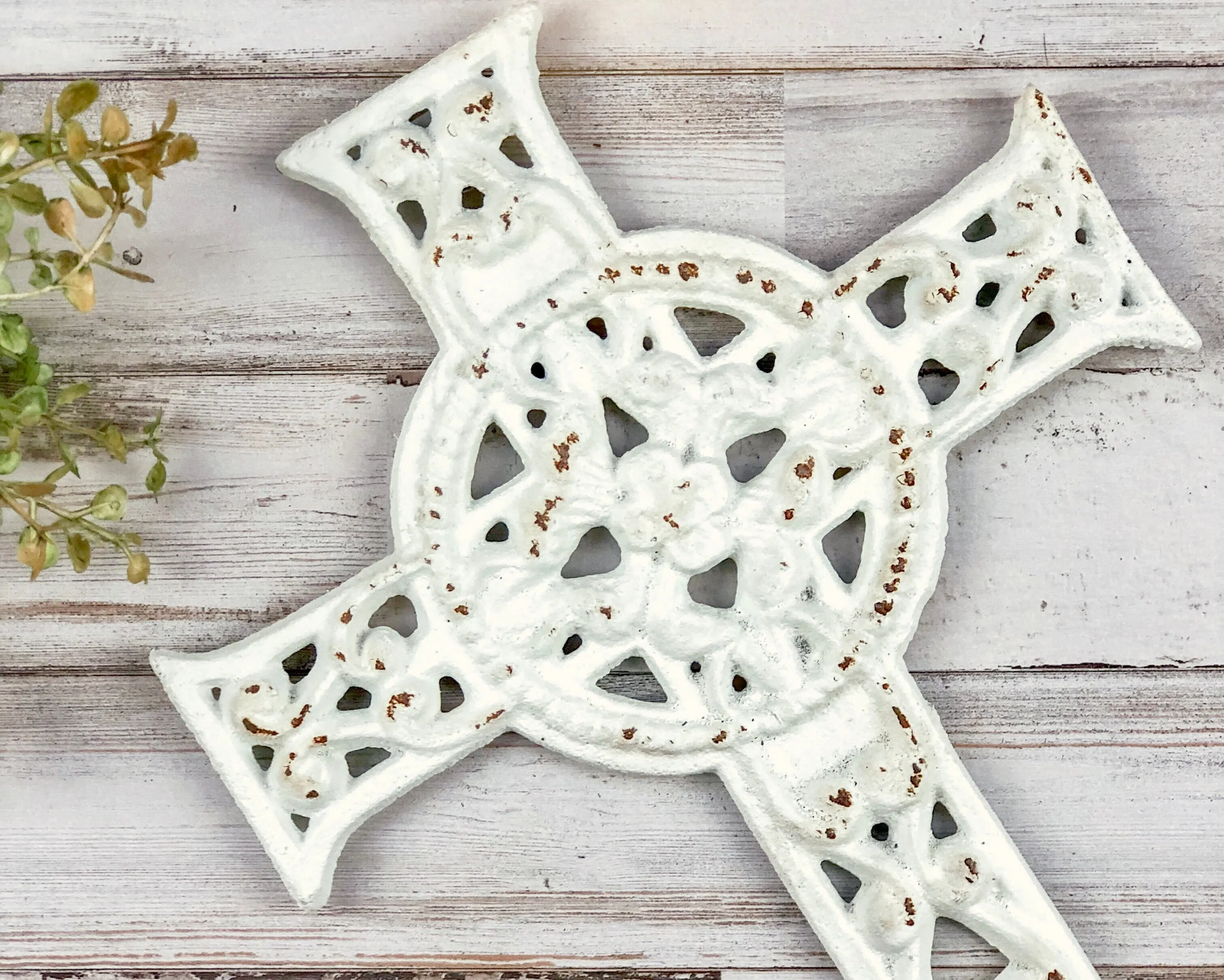 Ornate worn white iron wall hanging cross